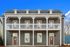 Charming duplex with a classic design, featuring a welcoming front porch and elegant double doors in a tranquil neighborhood.