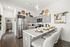 Chic modern kitchen with sleek stainless steel appliances, elegant grey cabinetry, and a stylish breakfast bar set for dining. Bright, airy space perfect for gourmet cooking and entertaining.