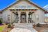 Inviting clubhouse entrance with modern architecture and inviting outdoor seating, perfect for relaxation and social gatherings.