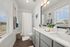 Bright and inviting bathroom with modern fixtures, dual sinks, and elegant decor, showcasing ample natural light through large windows.