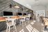 Contemporary co-working lounge with sleek computer stations, stylish wooden decor, and natural light enhancing a vibrant work atmosphere.