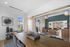 Chic open-concept living space featuring elegant dining area, modern decor, and inviting lounge with stylish leather seating.