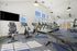 Modern and spacious fitness center featuring state-of-the-art gym equipment, natural light, and vibrant interior design.