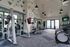 Modern, spacious gym with state-of-the-art equipment, vibrant decor, and motivational quotes promoting a healthy lifestyle.
