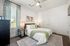 Inviting bedroom with cozy bed, elegant decor, and natural light, perfect for relaxation and comfort.