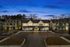 Charming row of townhouses glowing warmly under a twilight sky, showcasing modern architecture and inviting ambiance.