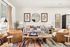 Inviting living room with modern design, featuring plush sofas, elegant armchairs, and stylish decor accents.