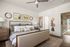 Elegant bedroom with cozy bedding, stylish artwork, and soft natural lighting creating a serene ambiance.