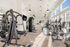 Bright and modern fitness center featuring state-of-the-art gym equipment, expansive windows, and sleek design.