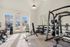 Bright and modern fitness center with state-of-the-art gym equipment, featuring large windows and a welcoming atmosphere.