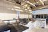 Exquisite outdoor kitchen with modern grills and sleek countertops in a sunlit patio setting.
