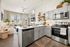 Modern open-concept apartment with sleek kitchen, cozy living area, and abundant natural light.