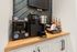 Inviting coffee bar setup featuring a sleek Keurig machine, a variety of flavored syrups, and an assortment of coffee pods for a perfect morning start.