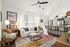 Inviting open-concept living space with cozy seating, vibrant area rug, and modern kitchen island, perfect for entertaining.