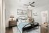 Inviting bedroom featuring a comfortable bed with cozy pillows, stylish lamps, and modern decor in a serene setting.
