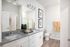 Modern bathroom featuring sleek granite countertops, elegant double vanity, and chic decor accents.