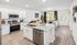 Bright and modern open-concept kitchen and living area with sleek granite countertops, stainless steel appliances, and stylish decor.