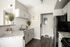 Kithchen with white cabinets, black refrigerator and grey and black stove
