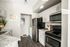 Kitchen with stove and black refrigerator