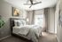 Bed in bedroom with ceiling fan
