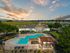 Resort inspired pool with grilling and lounging seating
