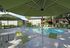 Pool area with tables, chairs and umbrellas