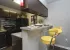 kitchen with black appliances and breakfast bar with stools