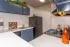 kitchen with black refrigerator and blue cabinets