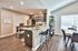 Modern open-concept kitchen and dining area with sleek appliances, stylish countertops, and elegant dining setup.