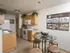 Oak Court kitchen with wood cabinets, white appliances, and adjacent dining area with round glass table.