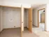 Laundry hookups and linen closet in Oak Court unit with dual-door access and clean neutral finishes.