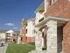 Close-up of Oak Court&rsquo;s exterior architecture, featuring brick facades, stone entryways, and covered balconies.
