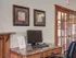 Second view of Embassy Ozark&rsquo;s business center with a desk setup and framed art on the wall.