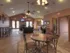 Open clubhouse space with multiple seating areas, workspace, and kitchen access at Embassy Ozark Apartments.