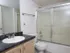 Modern bathroom at Willow Creek Apartments featuring a granite-look countertop and a sliding glass shower/tub combo.