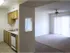Open-concept dining and living space with sliding glass door access to a patio, adjacent to the kitchen at Willow Creek Apartments in Springfield, MO.