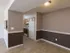 Separate dining area with two-tone paint and chair rail molding, offering a view into the fully equipped kitchen at Willow Creek Apartments.