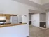 Bright dining space with tile flooring and access to the kitchen, complete with white appliances and chair rail molding.
