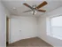 Bedroom with ceiling fan, neutral walls, and a window nook perfect for natural light at Willow Creek Apartments.