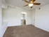 Bedroom at Willow Creek Apartments offering plush carpet, ceiling fan, and a view into the attached bathroom.