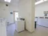 Alternate angle of the on-site laundry room at Willow Creek Apartments, showing open layout and ample machines.
