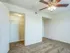 Spacious bedroom featuring a ceiling fan and open walk-in closet, providing ample storage at Willow Creek Apartments in Springfield, MO.