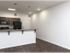 Spacious apartment kitchen with bar seating, sleek lighting, and wood-style floors at Market Street Apartments.