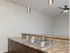 Dual-basin sink with stone-look countertops and under-cabinet lighting in a Market Street Apartment.