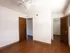Unfurnished bedroom featuring wood-style flooring, ceiling fan, and access to a walk-in closet&mdash;clean and minimal space.