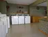 Laundry facility featuring top-load washers, storage cabinets, and patterned wallpaper at English Village Apartments.
