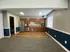 Spacious clubhouse interior featuring a full kitchen, large window, and two-tone wall paint.