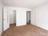 Spacious bedroom with double-door closet, white walls, and plush carpeting at English Village Apartments.