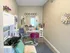 On-site beauty salon at Cobblestone Village featuring a shampoo station, styling chair, vanity mirror, and cozy d&eacute;cor with homey touches.