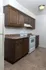 Kitchen with white electric range and wood cabinetry at Timbers Apartments, perfect for student living in Springfield, MO.